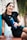 a woman sitting on a bench holding a water bottle