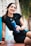 a woman sitting on a bench holding a water bottle