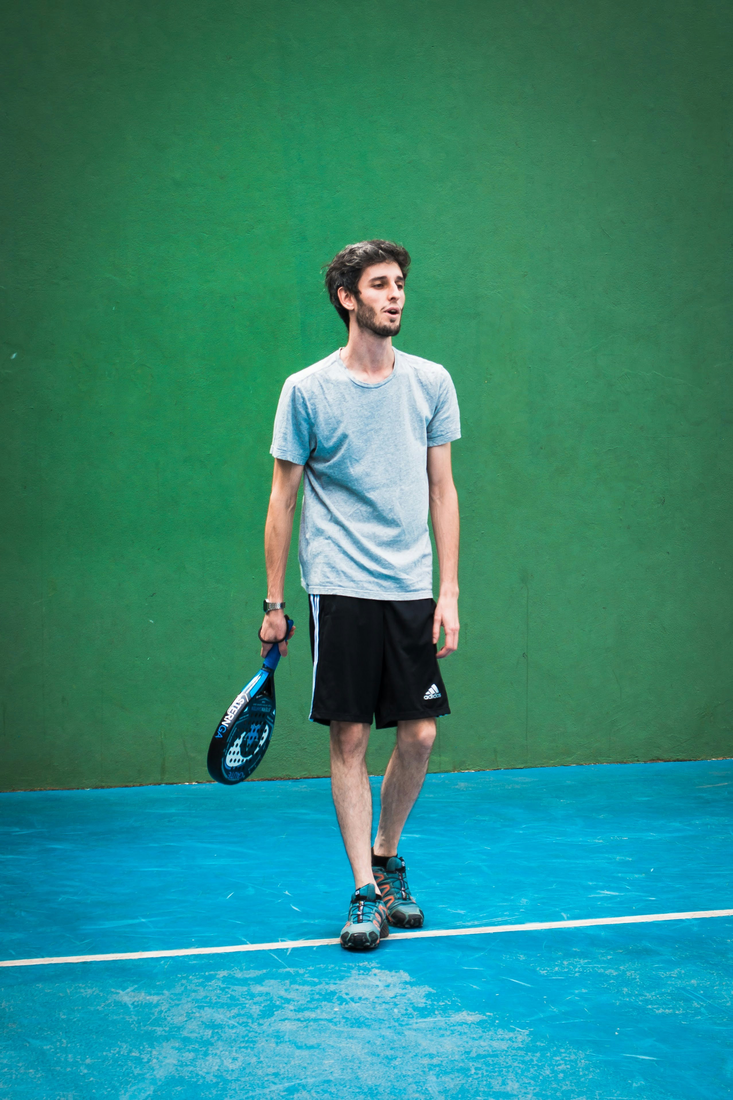 a man holding a tennis racquet on a tennis court