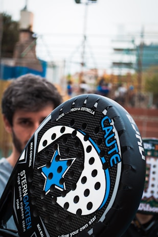a close up of a person holding a helmet