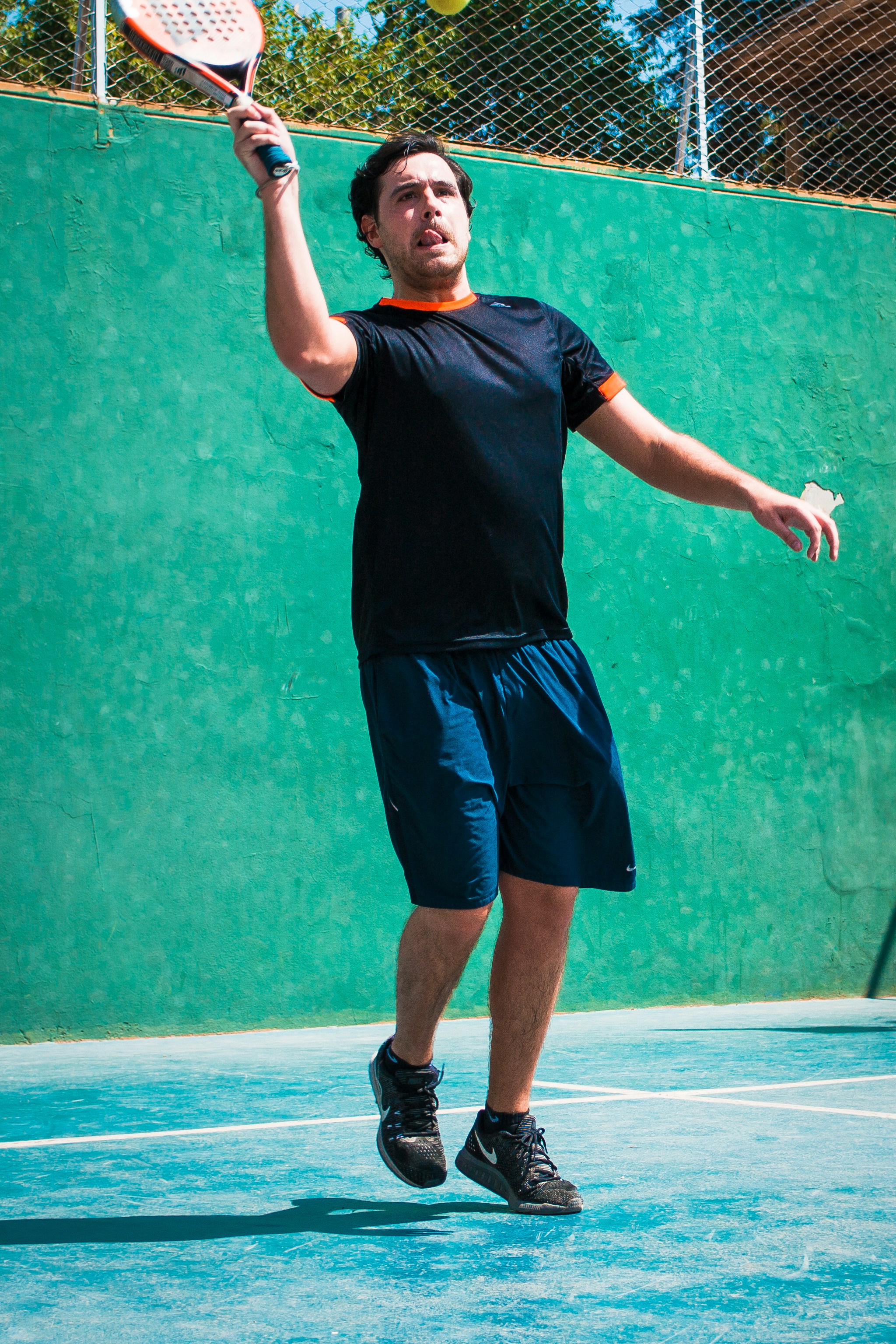 a man holding a tennis racquet on a tennis court