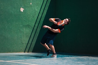 a man holding a tennis racquet on a tennis court