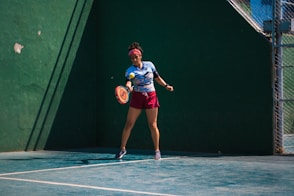 a female tennis player in action on the court