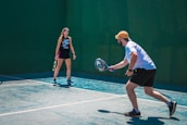 a man and a woman playing tennis on a tennis court