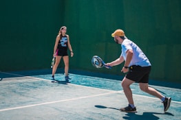 a man and a woman playing tennis on a tennis court
