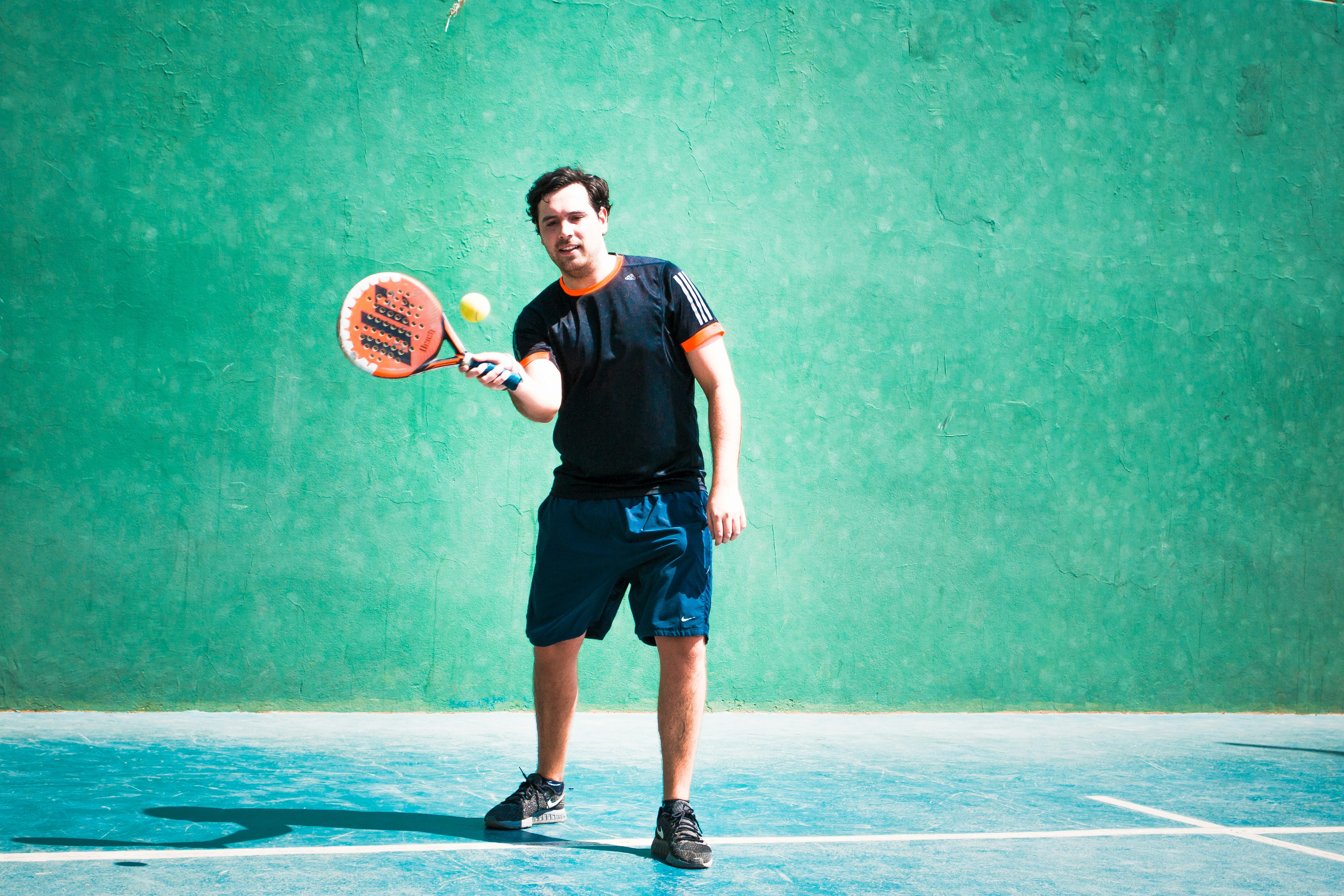 a man holding a tennis racquet on a tennis court