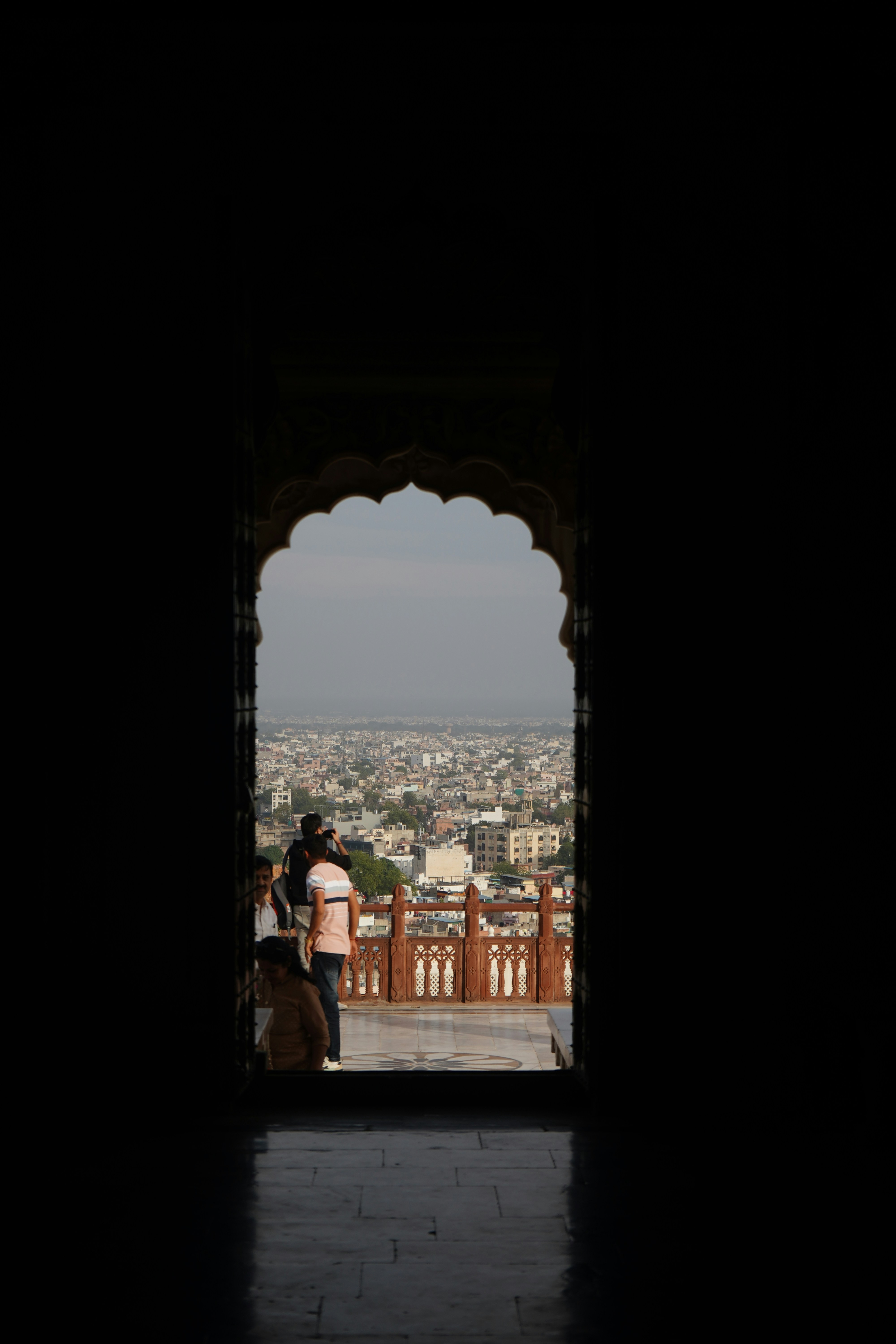 a man standing in a doorway looking at a city