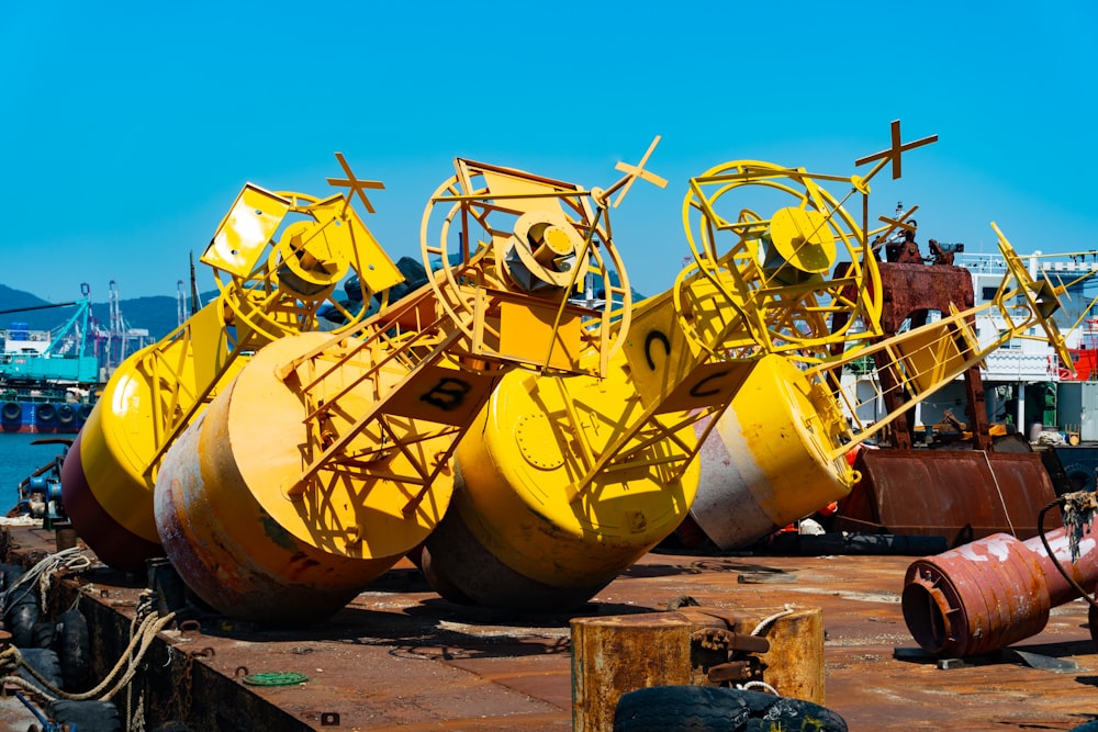 a group of large yellow machinery sitting on top of a dock