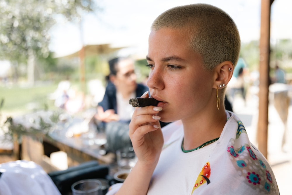 a woman eating a piece of chocolate cake