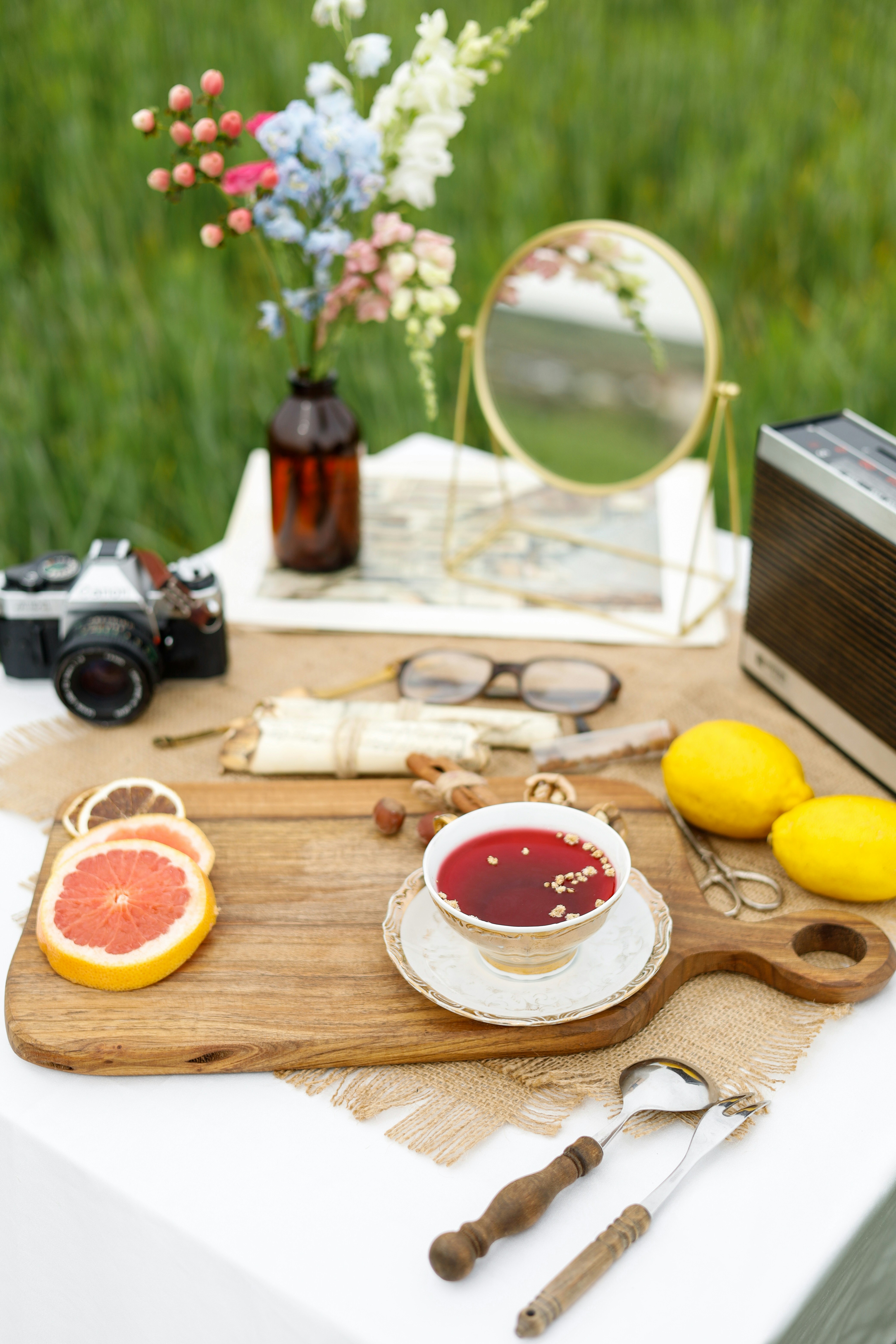 a wooden cutting board topped with a bowl of fruit