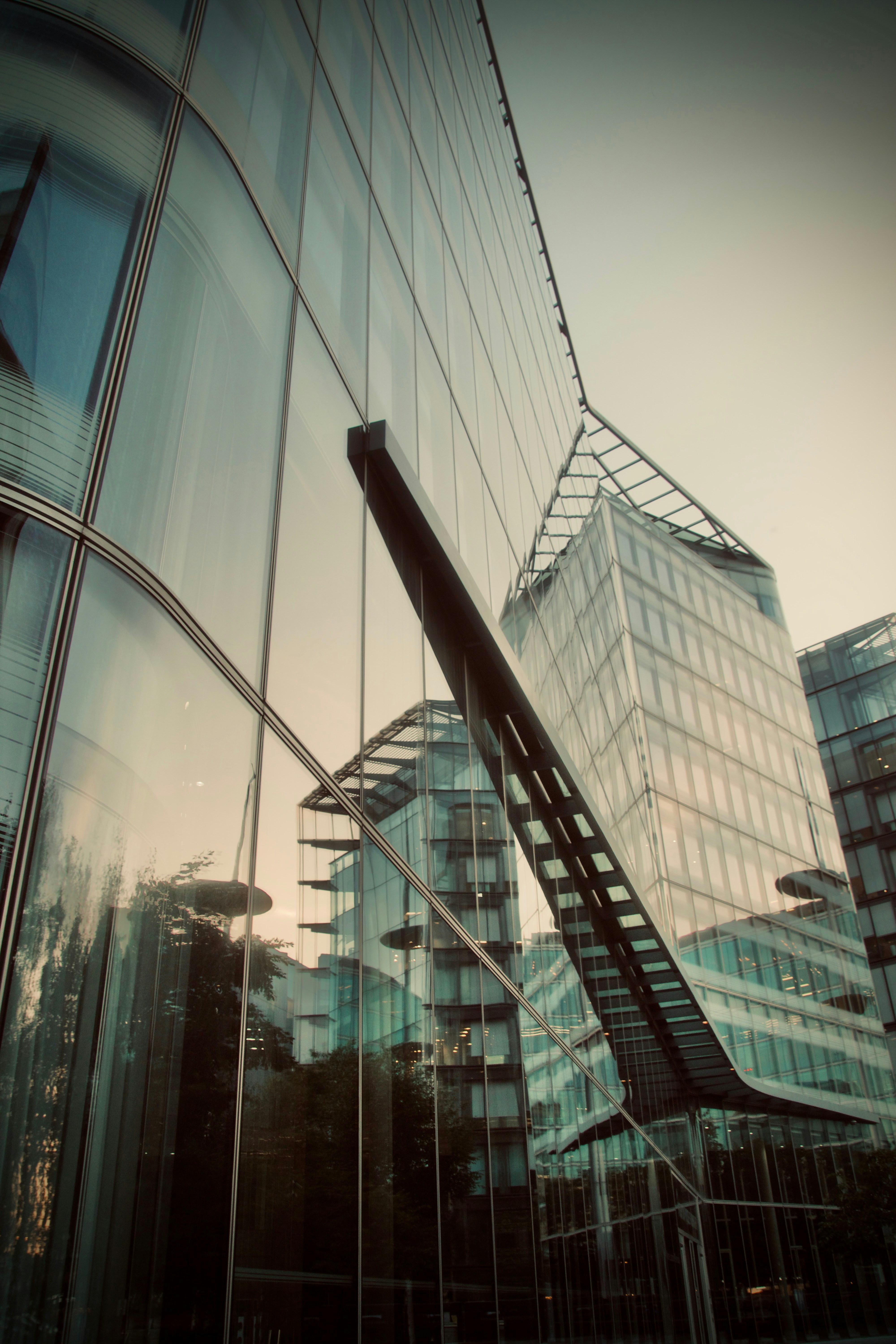 a glass building with a spiral staircase in front of it