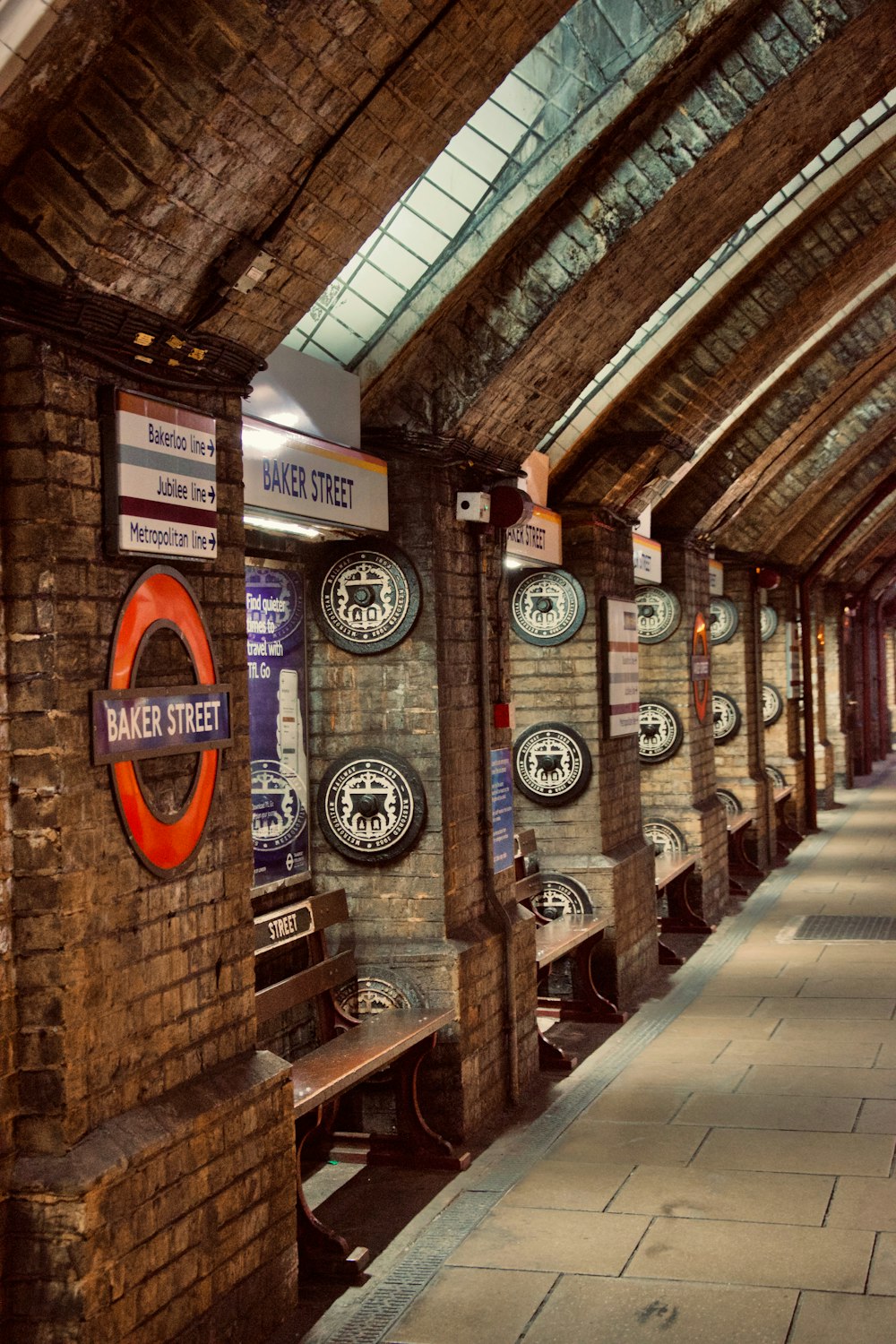 a train station with a bunch of signs on the wall