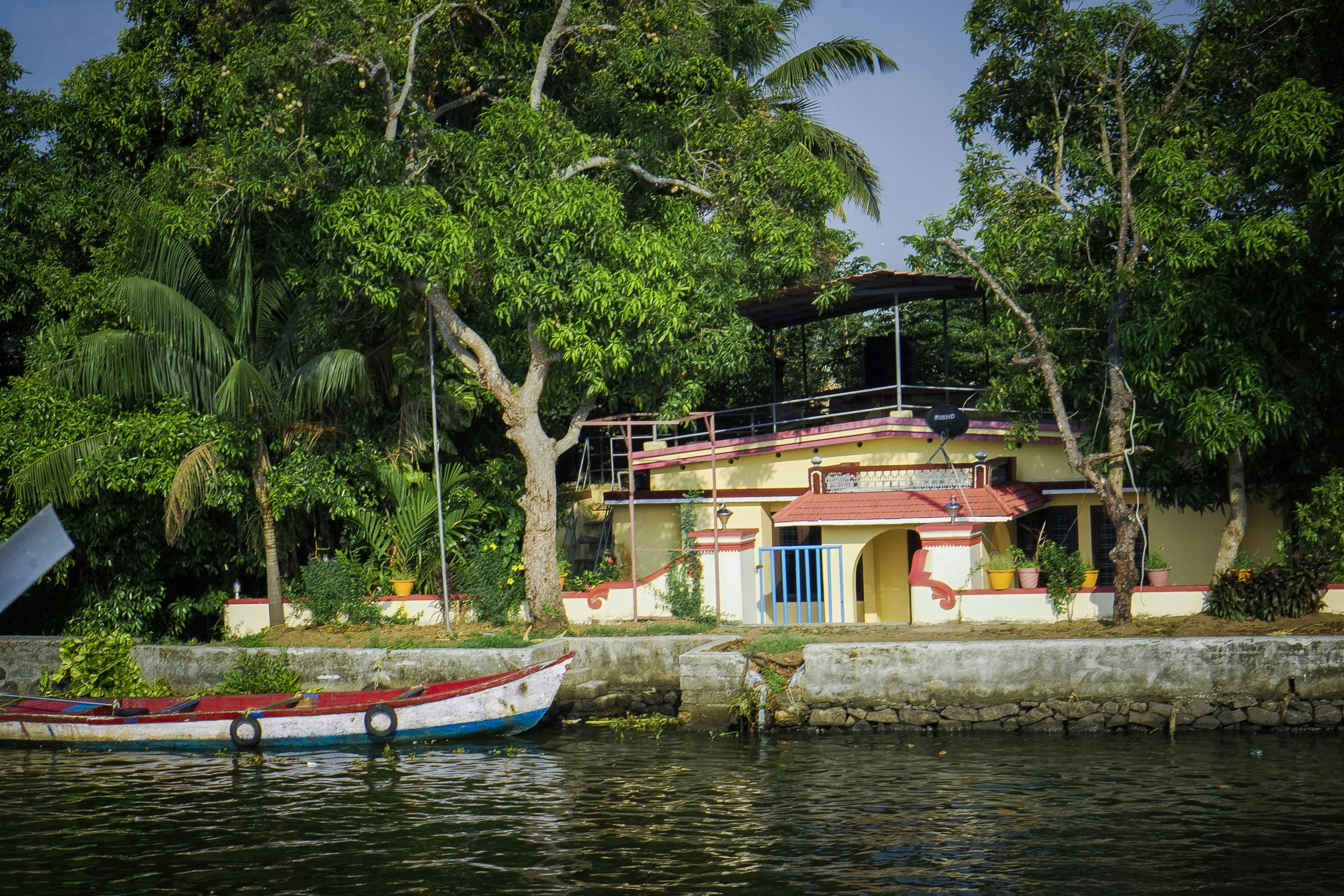 two boats are docked in front of a house