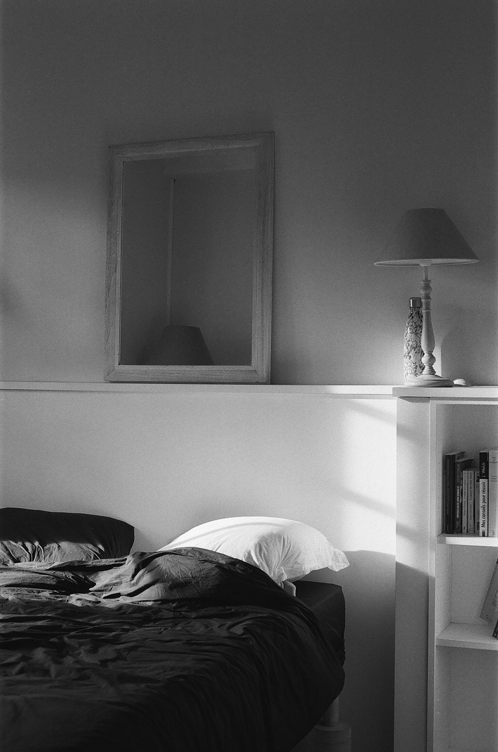 a black and white photo of a bed in a bedroom