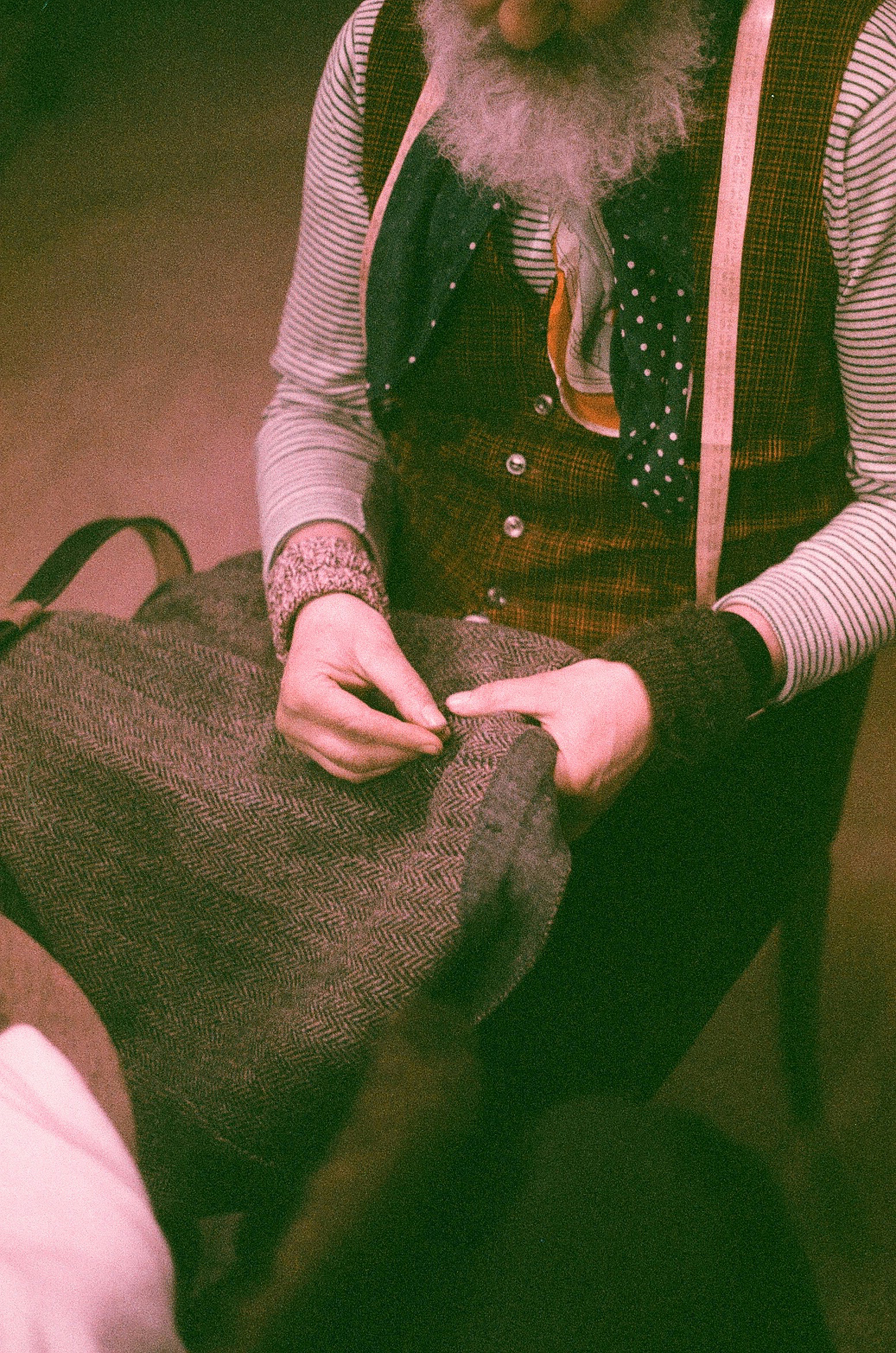 a man with a long beard is holding a piece of cloth