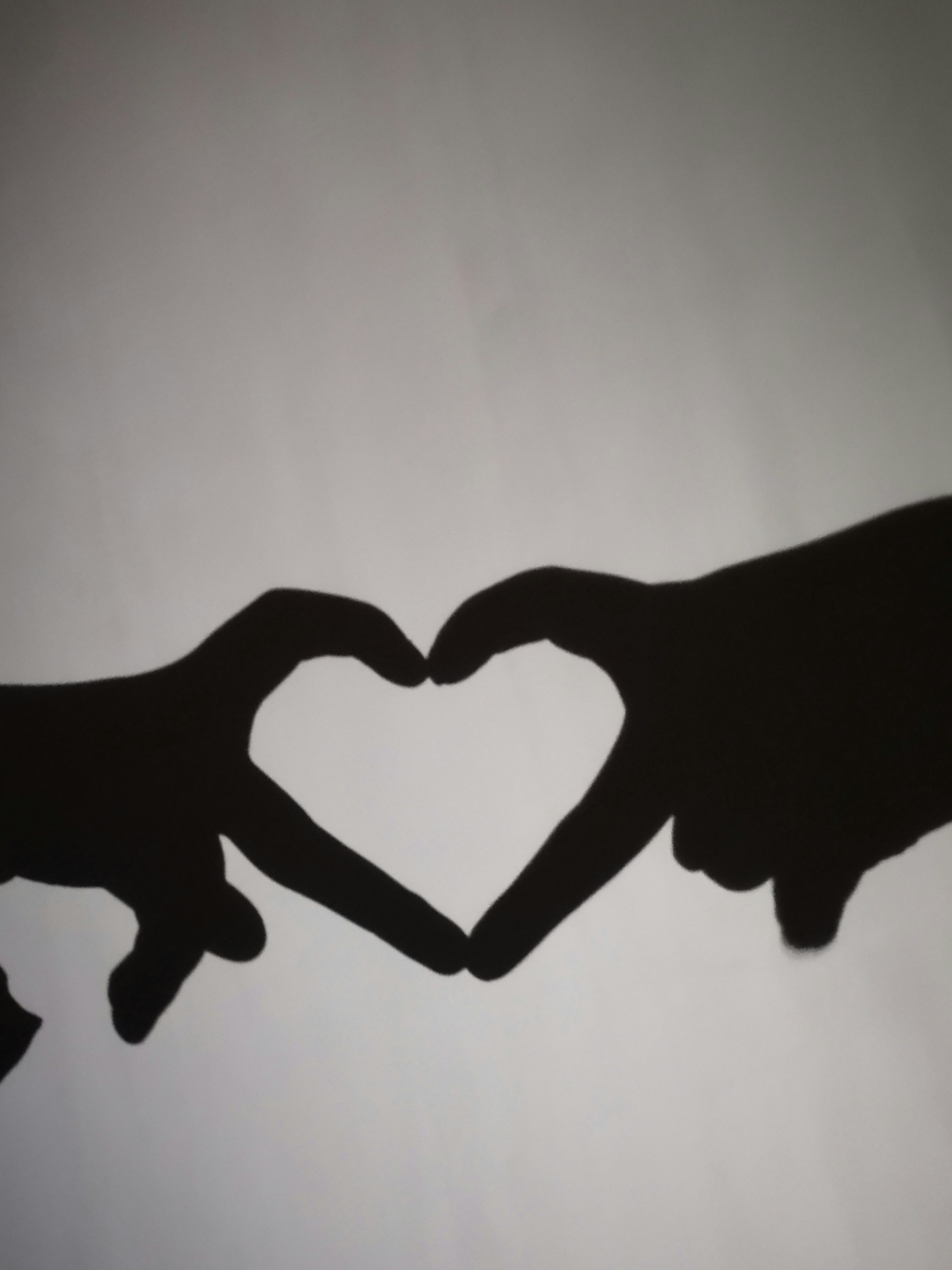 two hands making a heart shape with their fingers