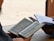 a man sitting at a table reading a book