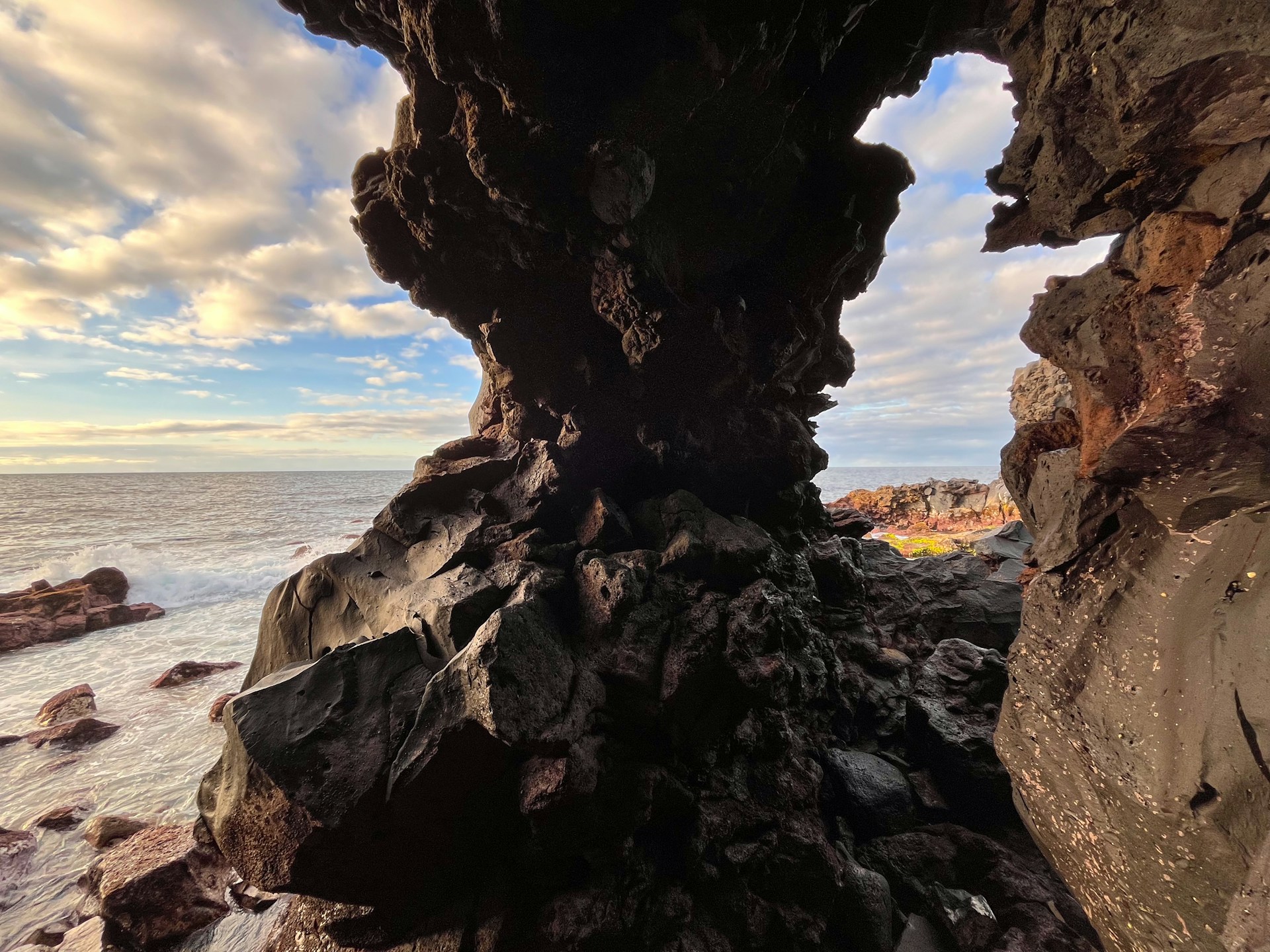 a rock formation on the shore of a body of water