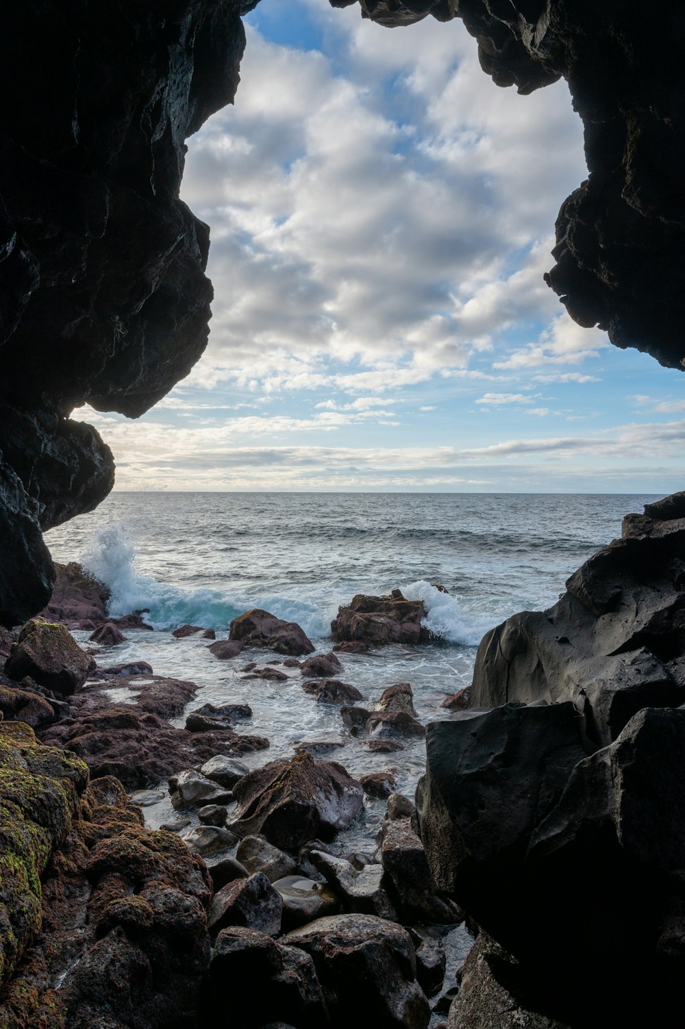 a view of the ocean from inside a cave