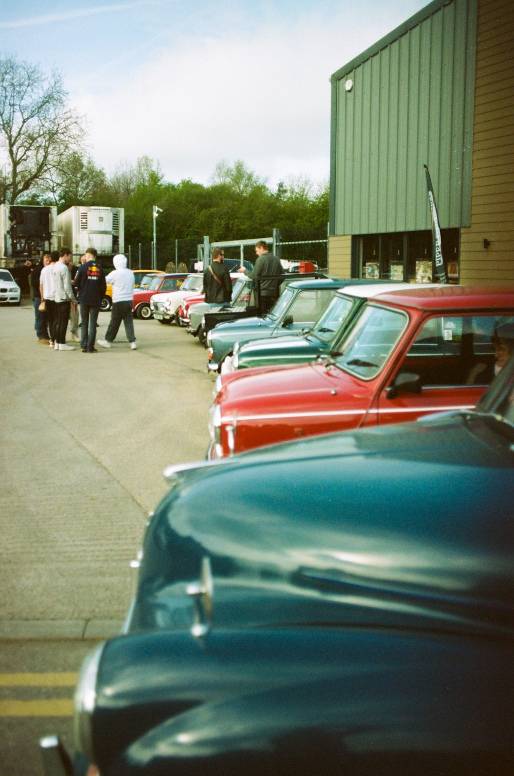 a group of cars parked next to each other in a parking lot