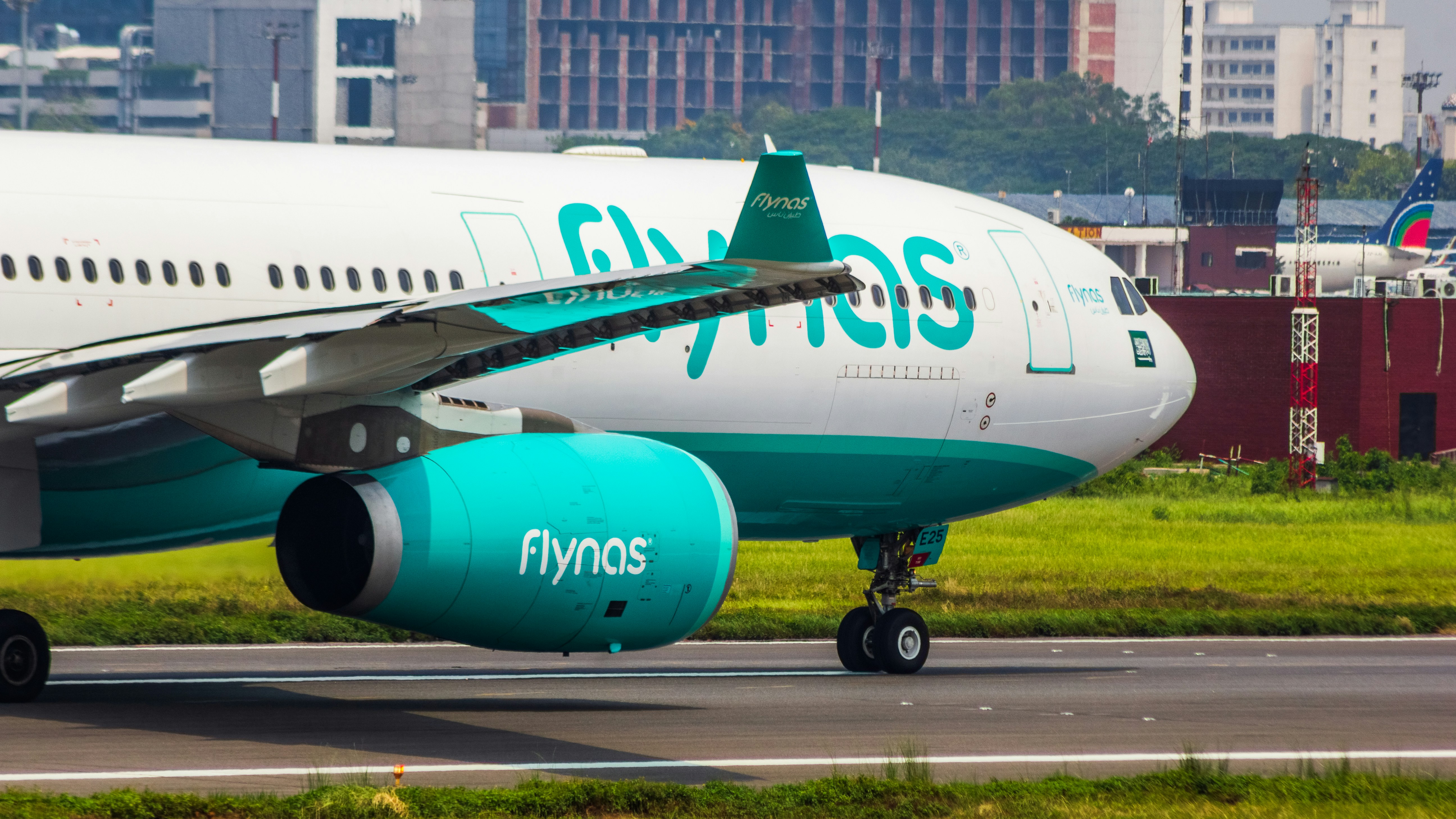 a large jetliner sitting on top of an airport runway, flynas A330 aircraft closeup