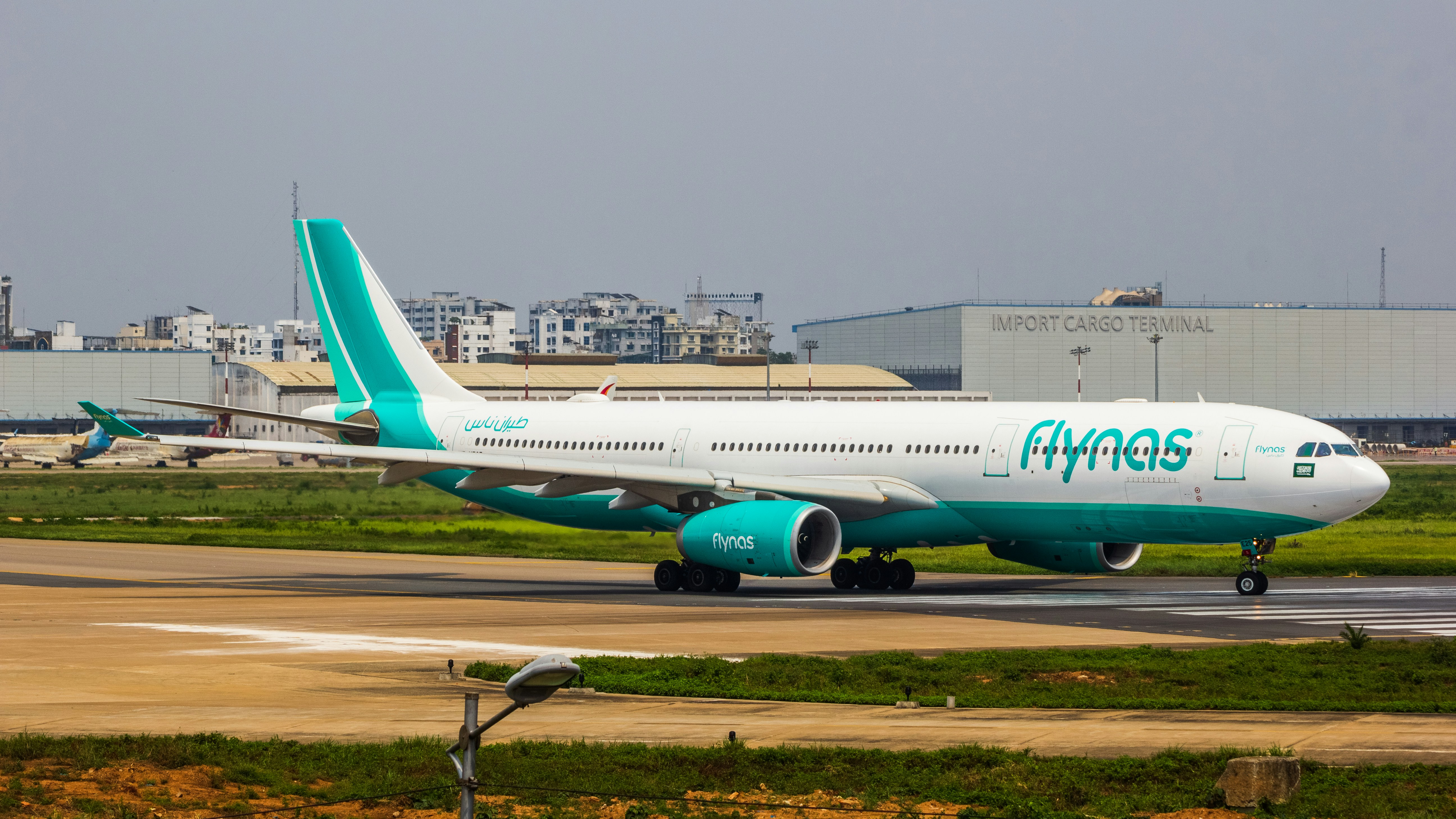 a large passenger jet sitting on top of an airport runway, flynas A330 aircraft closeup