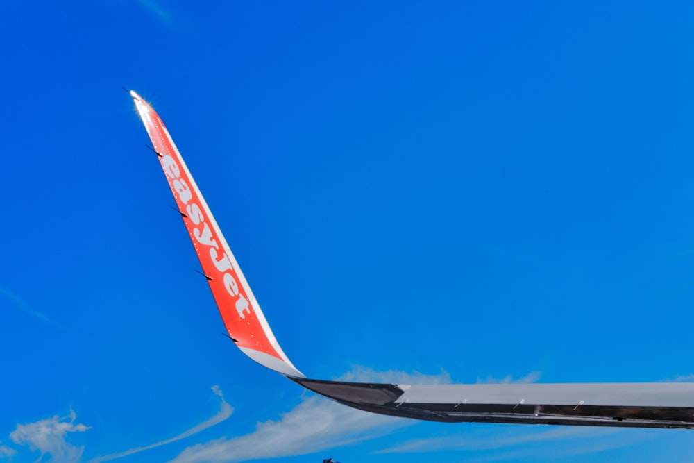 the tail end of an airplane against a blue sky