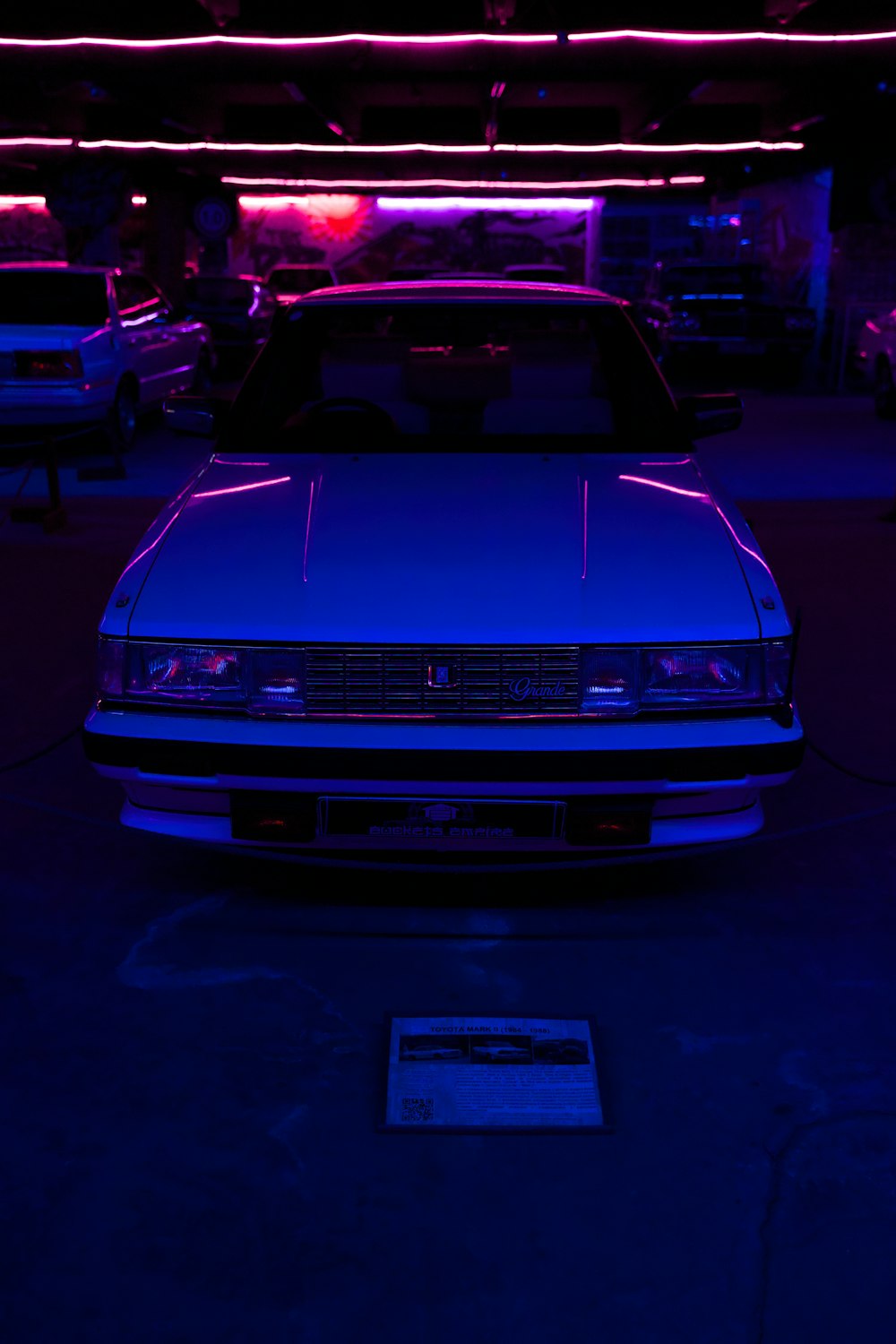 a car parked in a garage with a purple light