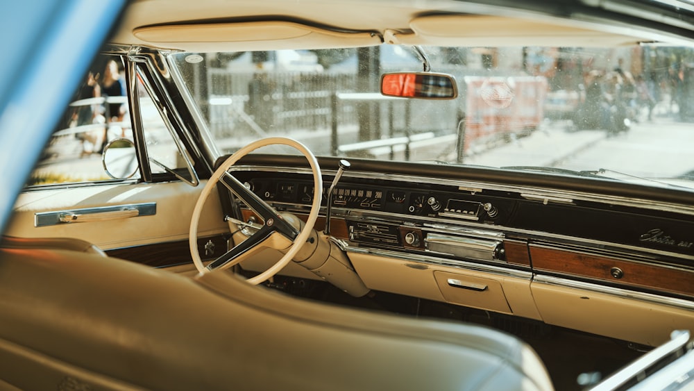 the interior of a car with a steering wheel and dashboard