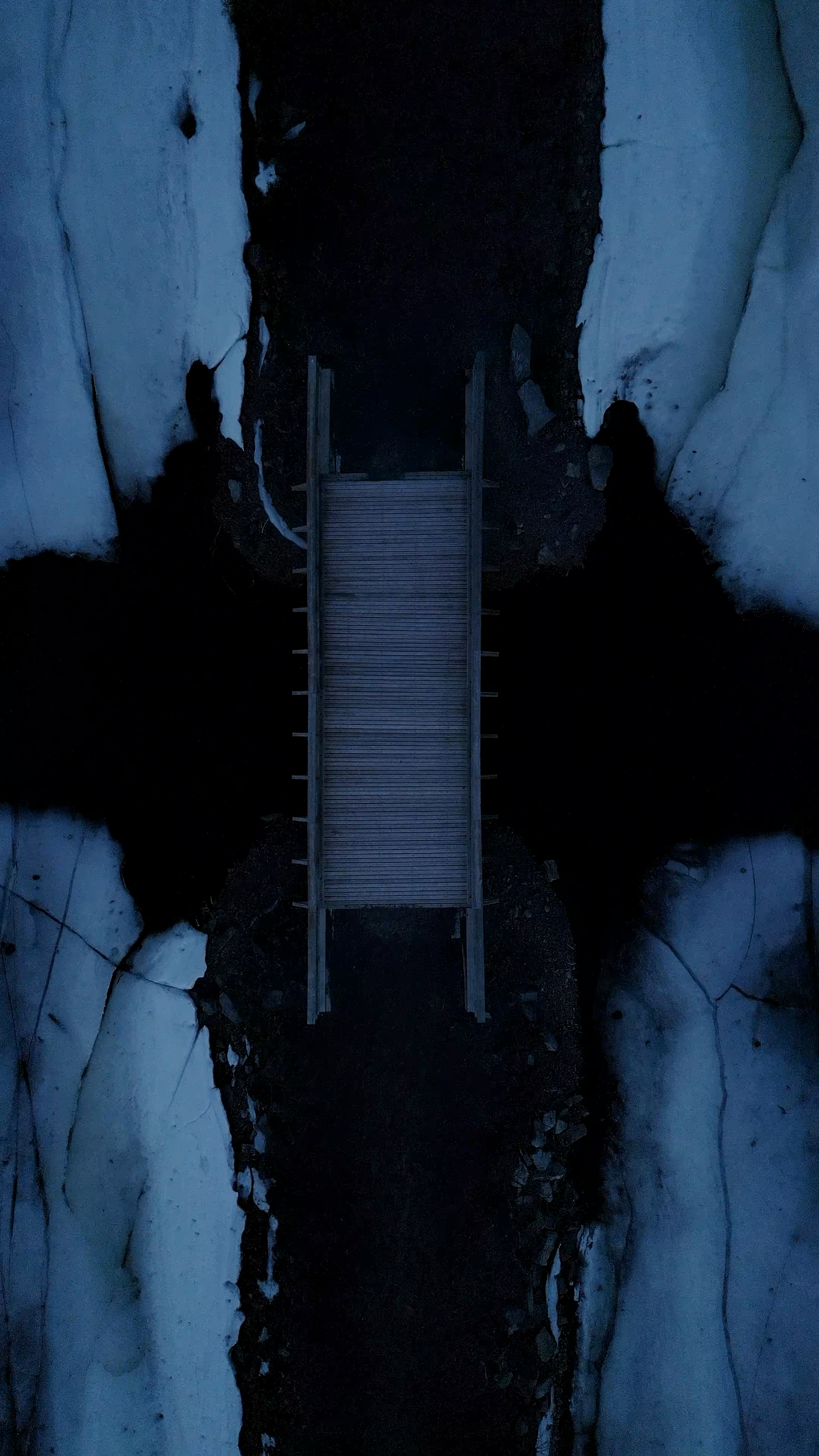 a wooden walkway in the middle of some snow