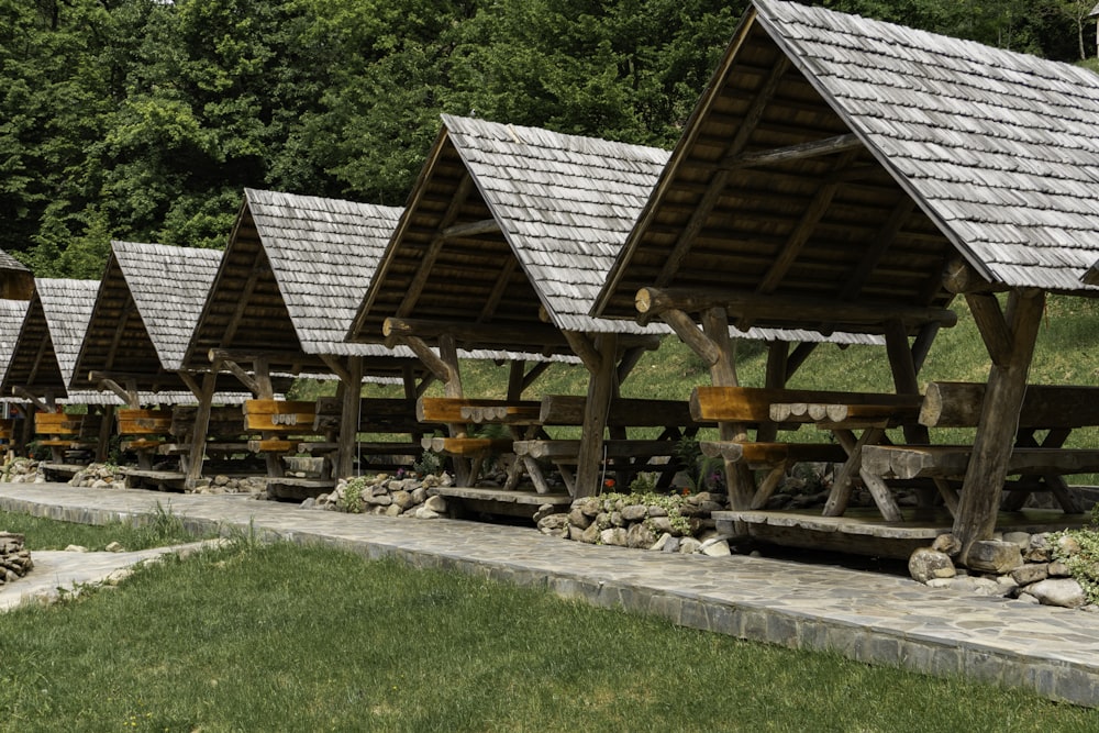 a row of wooden buildings with bells on them