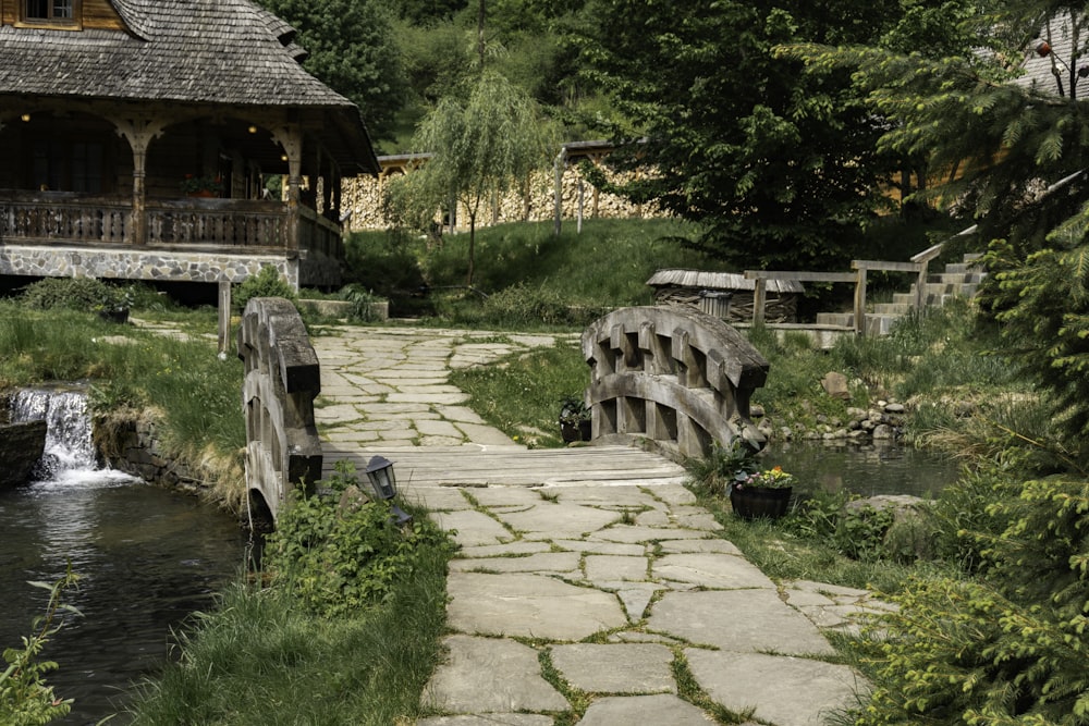 a stone path leading to a wooden house
