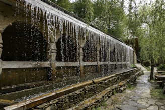 a water fountain with water pouring out of it