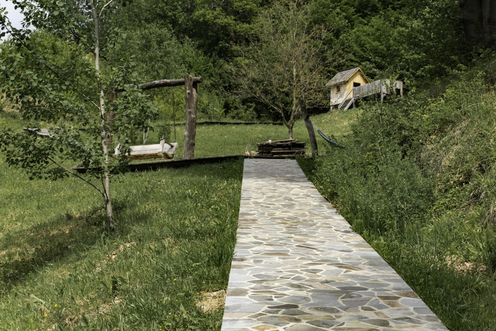 a stone path leading to a small cabin
