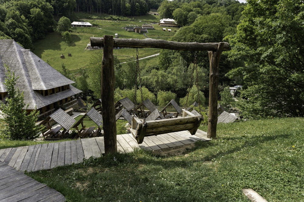 a wooden bench sitting on top of a lush green hillside