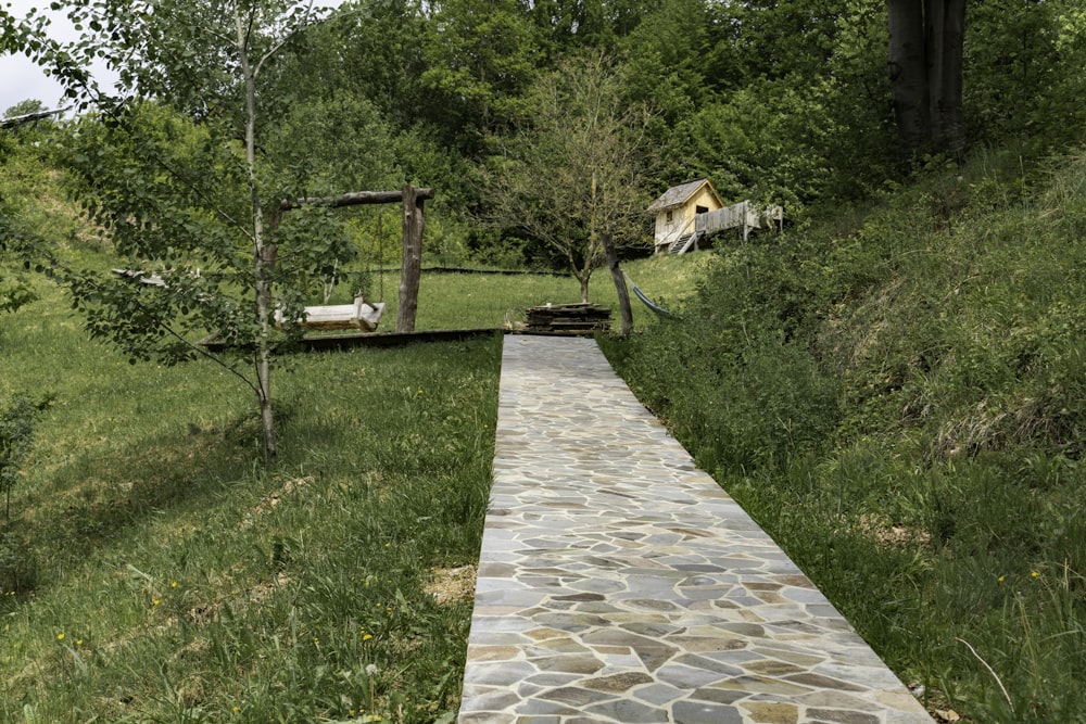 a stone path going up a grassy hill