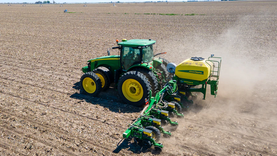 Tractor with sprayer working an open field