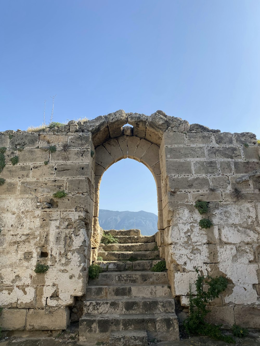 a stone wall with steps leading up to it