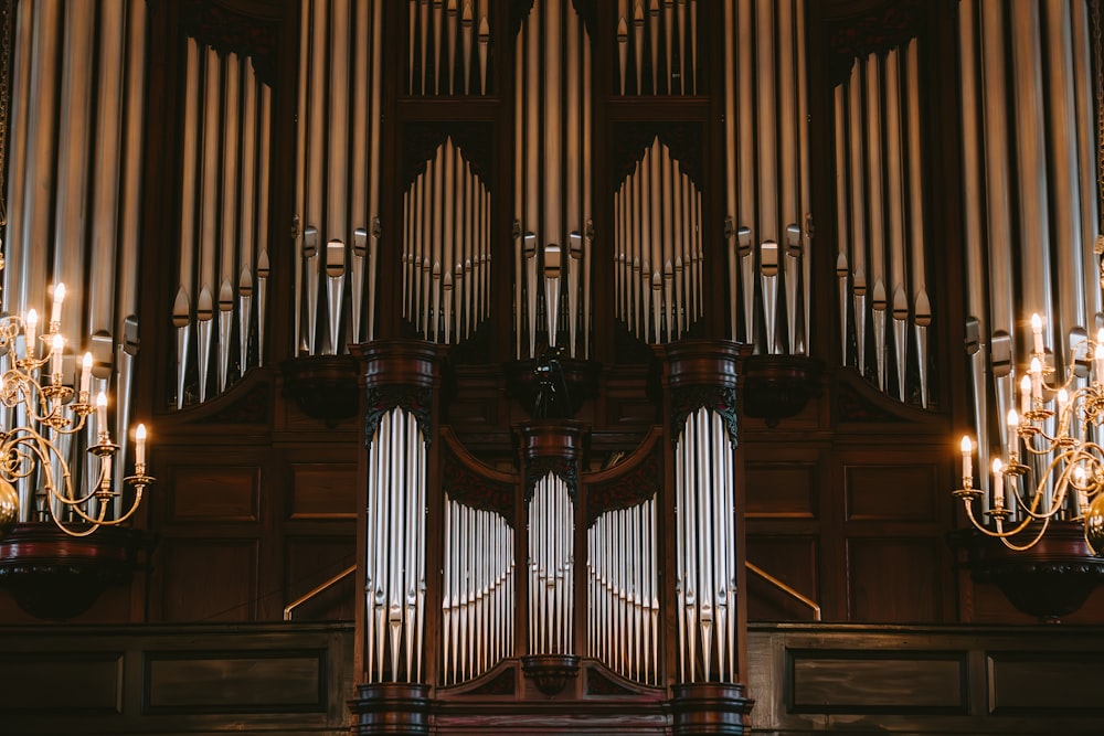 a pipe organ in a church with chandeliers