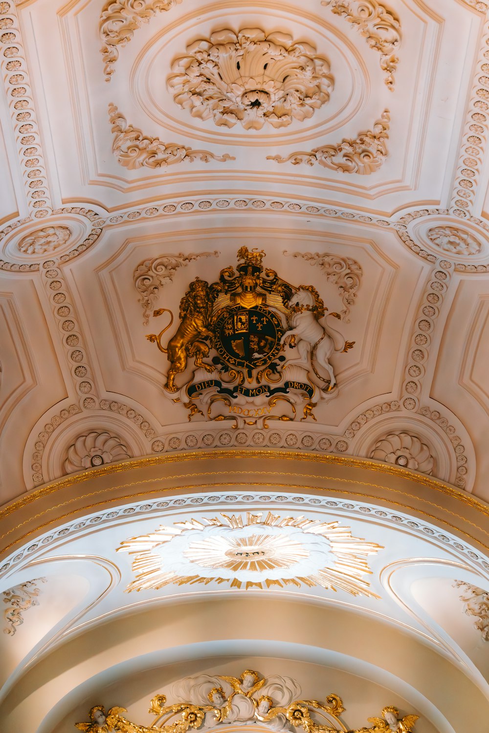 the ceiling of a church with a gold and white design