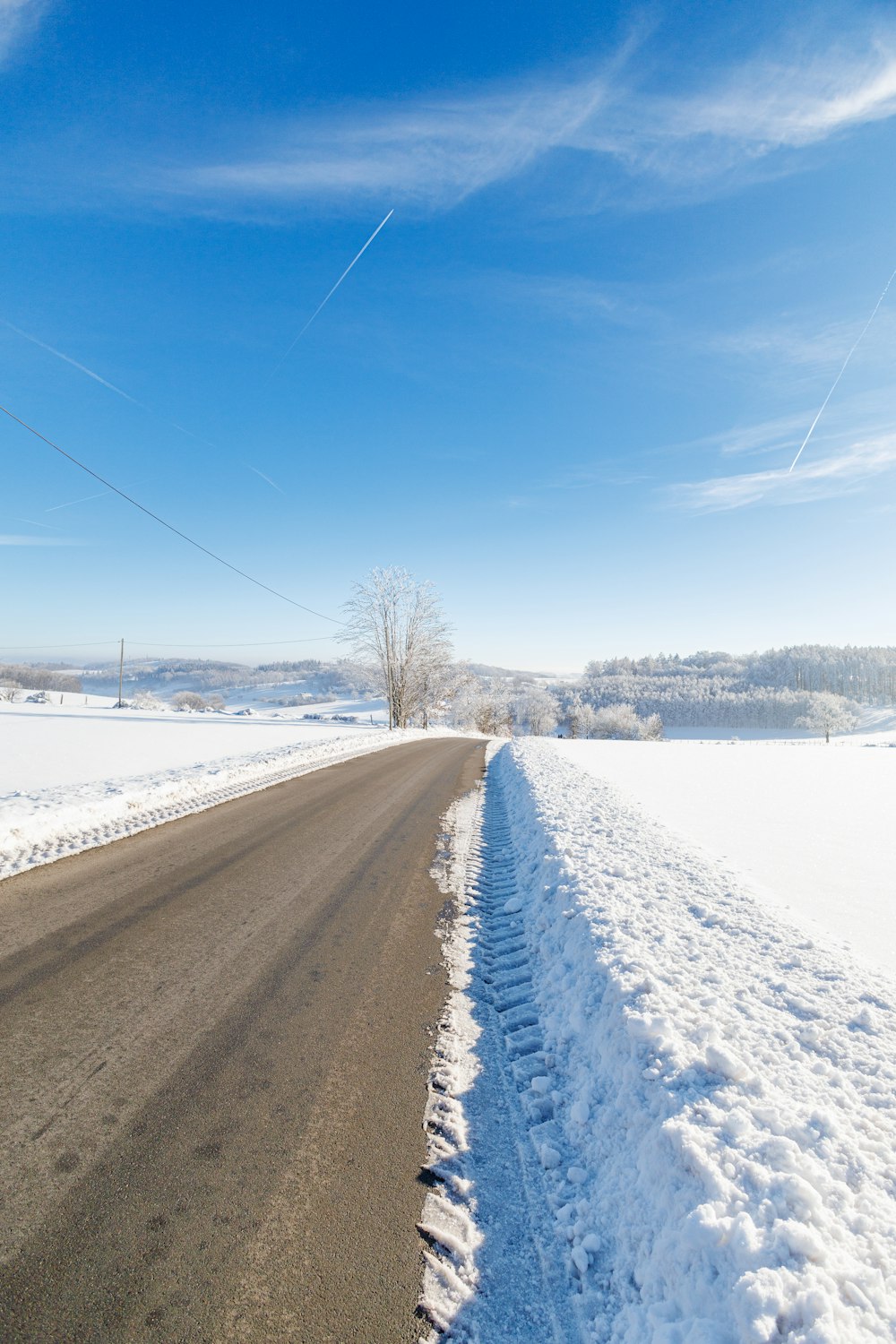 a road that has snow on the side of it