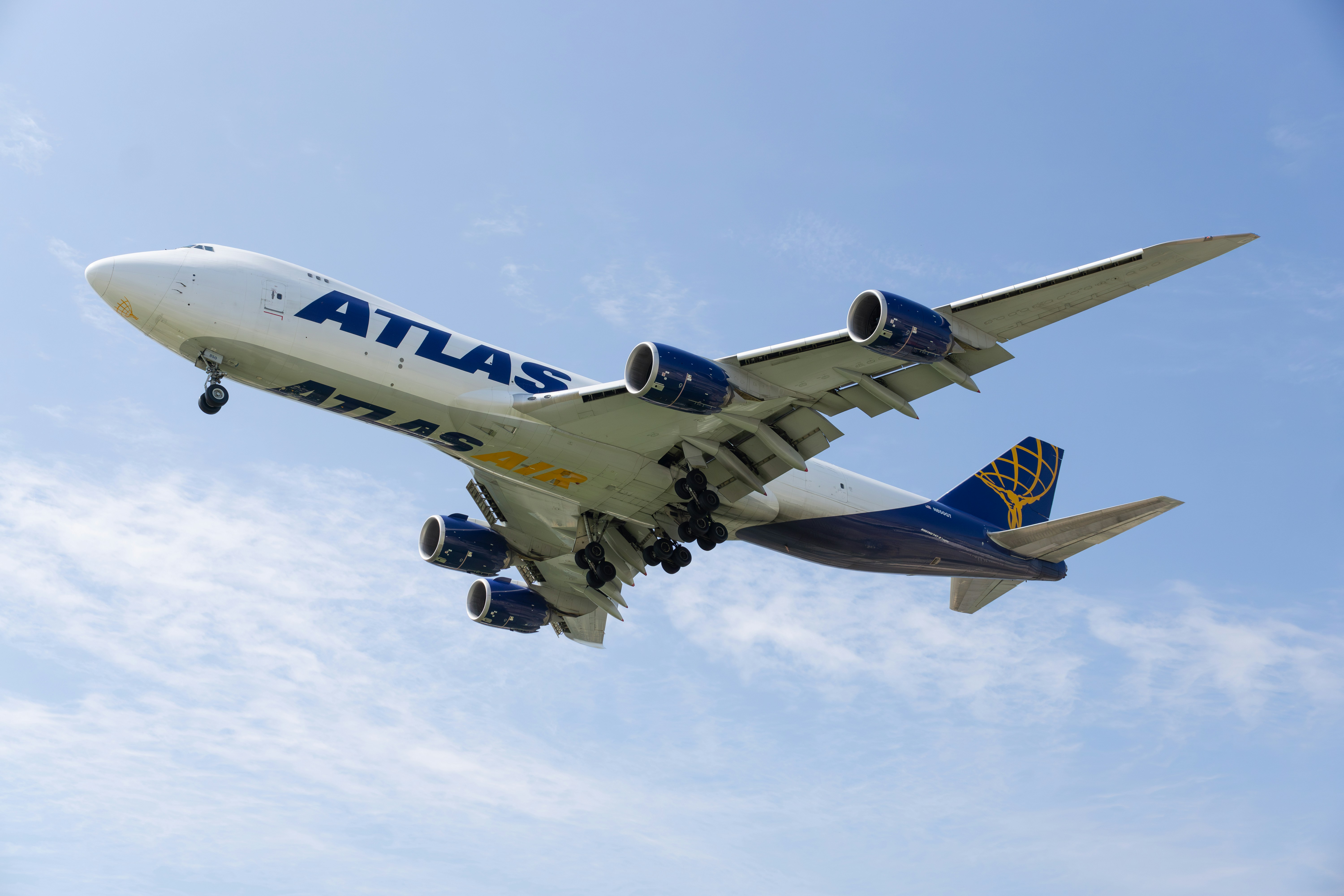 a large jetliner flying through a blue sky, 