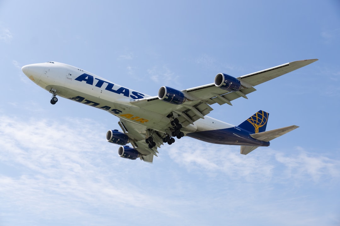 a large jetliner flying through a blue sky,