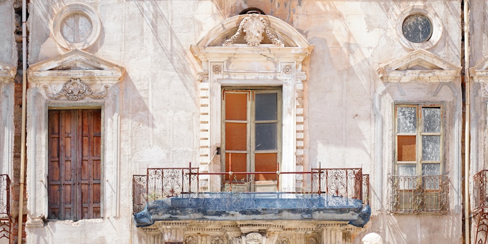 an old building with a statue in front of it