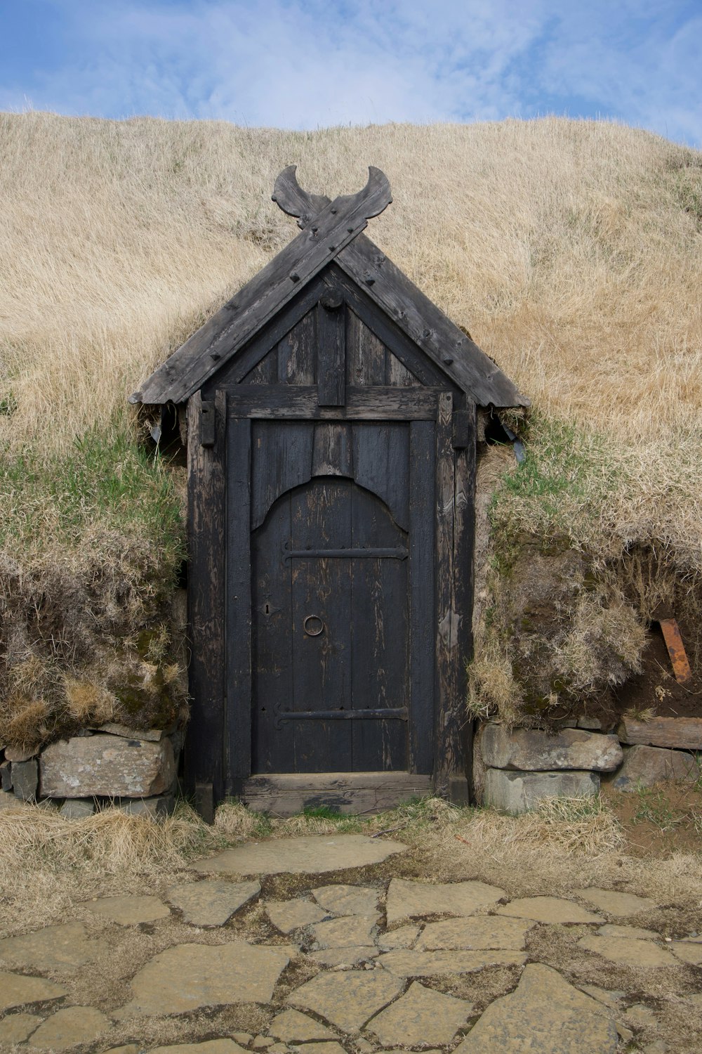a wooden door with a cross on top of it