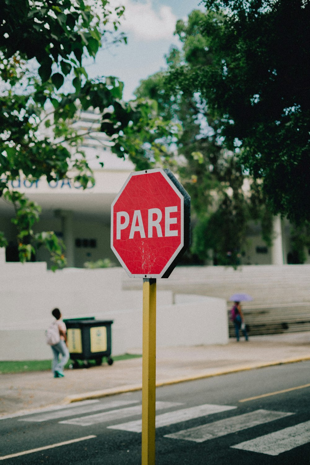 a red stop sign sitting on the side of a road