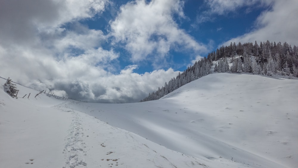 a snow covered ski slope with a sky background