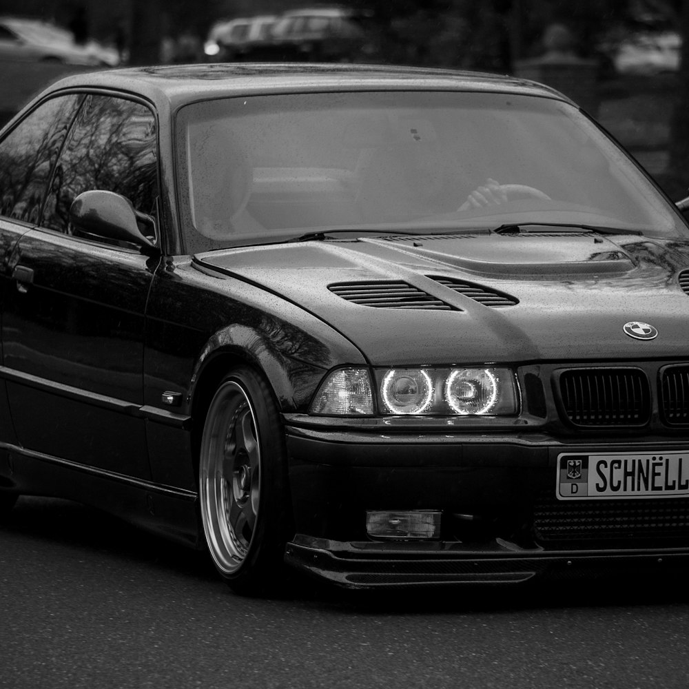 a black and white photo of a bmw