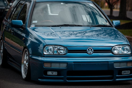 a blue car parked on the side of the road