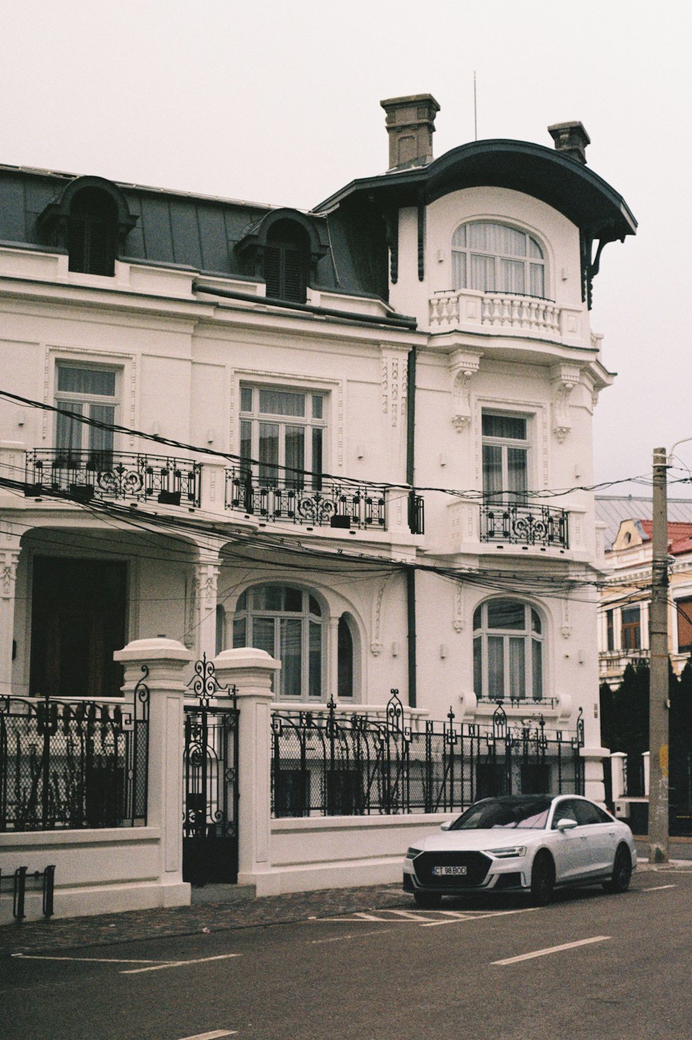 a car parked in front of a white building